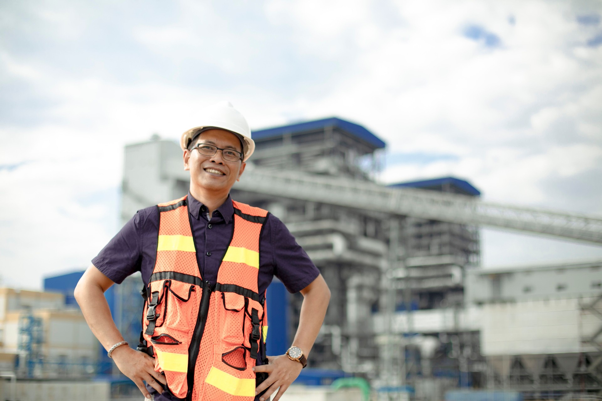 industrial engineer in hard hat wearing safety jacket. He works at the coal power plant